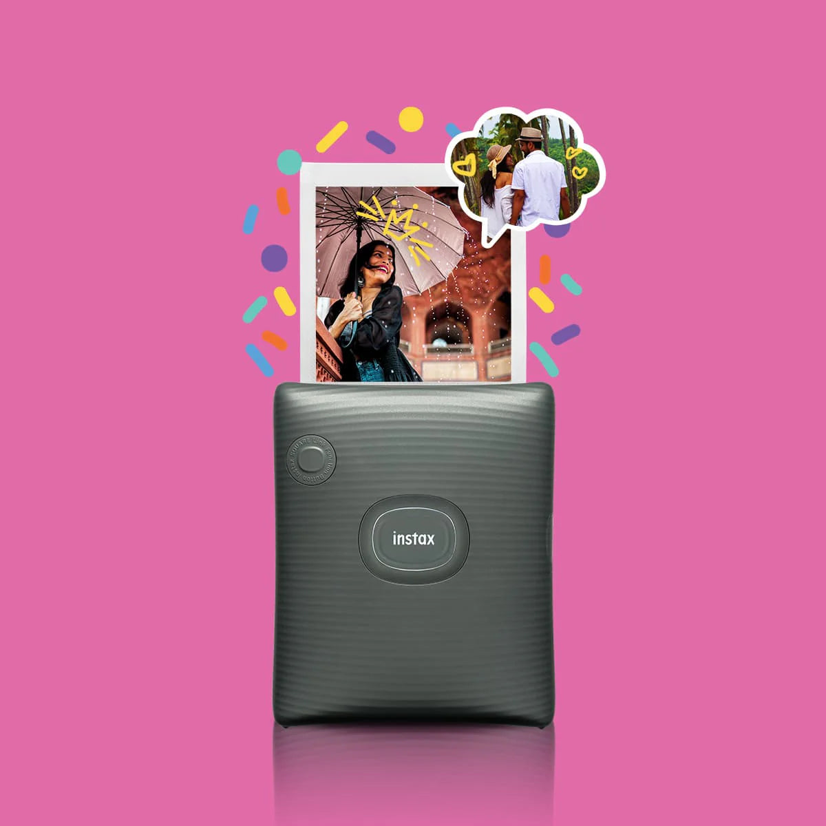Instax printer on a pink background with colorful confetti and a photo of a woman holding an umbrella.