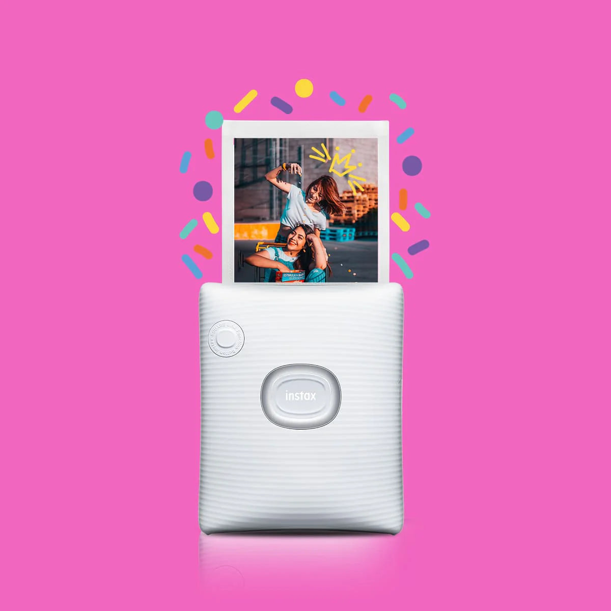 White instant camera with a photo of a couple on a pink background
